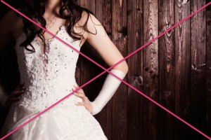 bride standing against wooden background
